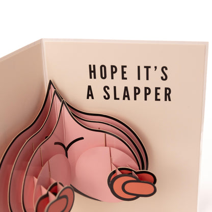 Interior shot of hilarious birthday card with message "hope it's a slapper".